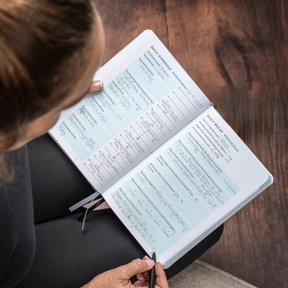 A woman reviewing a filled-in Daily Schedule and Daily Recap